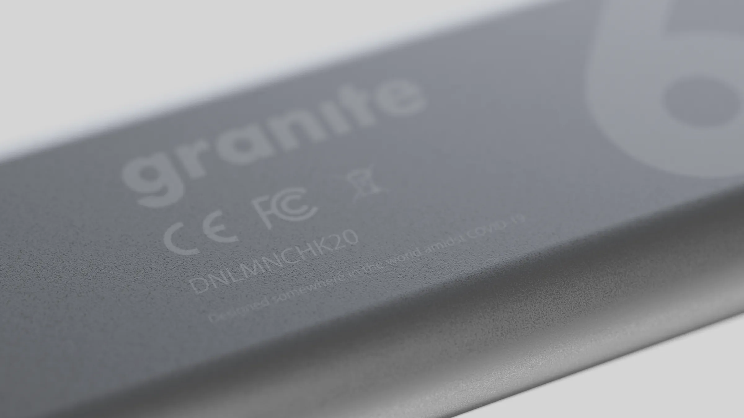 CAD render: close-up of a grey device housing embossed with “granite” and regulatory marks